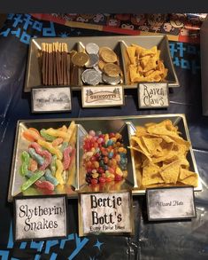 several trays filled with different types of snacks and coins on top of a table