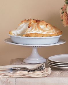 there is a pie on the table with plates next to it