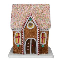 a gingerbread house is decorated with sprinkles