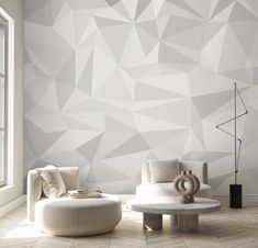 a modern living room with white furniture and geometric wallpaper