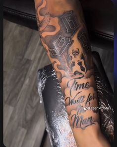 a person with a tattoo on their arm that says time to wait for the meal