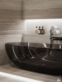 a black and white photo of a bathtub with soaps on the wall next to it