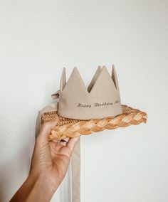 a person holding a basket with a crown on it