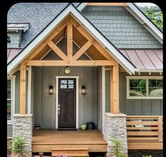 the front porch of a house with stone pillars and wooden steps leading up to it