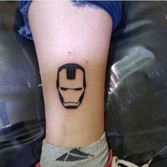 a small iron man tattoo on the leg