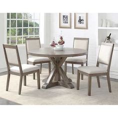 a round dining table with four chairs around it