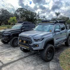 two trucks parked next to each other in a parking lot