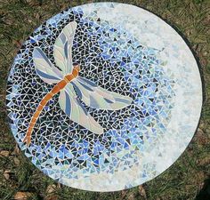 a mosaic plate with a dragonfly on it