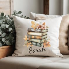 a pillow that has books on top of it with the words,'sarah '