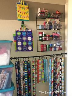 a closet filled with lots of craft supplies and wrapping paper hanging from the wall next to it