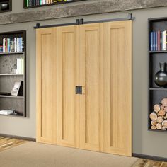 an empty room with bookshelves, shelves and a wooden door in the center