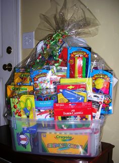 a large plastic basket filled with toys on top of a wooden table next to a door