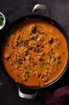 a skillet filled with food on top of a table