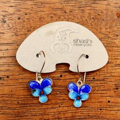 This graceful, Art Nouveau inspired design shows a pansy flower in bloom. Handcrafted of 24k gold over sterling silver. The enameled earrings are offered in hinged french backs for pierced ears. Size: 1 1/4 inches.The Shashi earrings offered here are vintage stock from the 1970's and 1980's. They were designed by the Shashi Singapuri, crafted by hand, and were part of a line featured on the cover of vogue (quite a handful of times) and numerous other fashion magazines. Nickel-free Enamel Flower Earrings Gift, Gift Nickel-free Enamel Flower Earrings, Adjustable Enamel Earrings With Ear Wire, Flower-shaped Enamel Flower Earrings For Gift, Nickel-free Enamel Flower Jewelry, Nickel-free Enamel Flower Earrings, Flower Shaped Enamel Earrings For Gift, Enamel Flower Earrings For Gift, Enamel Flower Charm Earrings