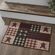 a wooden bench sitting next to a rug on the floor