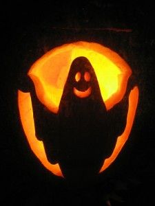 a carved pumpkin with a ghost in the center