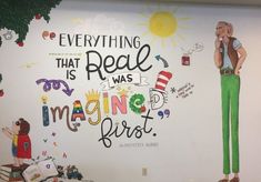 there is a mural on the wall in an office building that says, everything that is real is imagine first