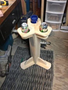 a table that has some cans on top of it in the middle of a workbench