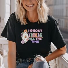 Celebrate the spooky season in style with our "I ghost people all the time" Halloween T-shirt! This eye-catching design features playful fonts and eerie graphics, perfect for adding a touch of Halloween spirit to your wardrobe. Made from soft, high-quality fabric, this shirt is comfortable for all-day wear, whether you're trick-or-treating, attending a Halloween party, or simply enjoying the autumn festivities. Available in various sizes, it's an excellent gift for Halloween enthusiasts of all a Novelty Black T-shirt As A Gift, Novelty Black T-shirt For Gift, Novelty Black T-shirt As Gift, Casual T-shirt With Character Print For Gift, Casual T-shirt With Character Print As Gift, Trendy Black T-shirt For Gift, Casual Halloween T-shirt For Gift, Halloween Graphic Print Top As Gift, Casual Halloween Tops For Gifts