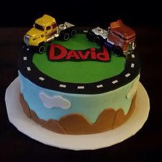 a birthday cake with cars and trucks on it