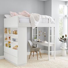 a white loft bed sitting next to a desk