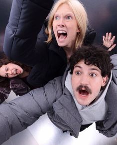 three people are posing for the camera with their mouths open