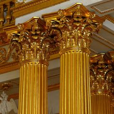 two gold pillars in the middle of a room