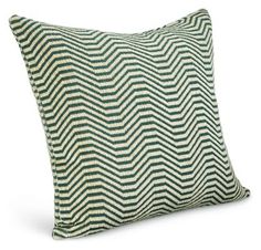 a green and white chevroned pillow on a white background with an arrow pattern