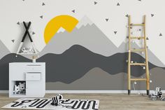 a room with a ladder and mountains painted on the wall in yellow, grey and white