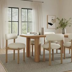 a dining room table with four chairs around it