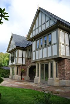 a large house with lots of windows in the front yard