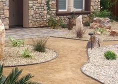 a stone house with landscaping in the front yard