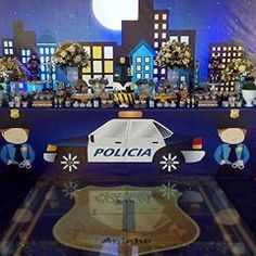 a police car is on display in front of a cityscape with flowers and wreaths