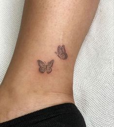 two small butterflies on the ankle tattoo design for women's feet, one is black and white