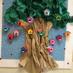 a tree made out of brown paper with bird houses on it