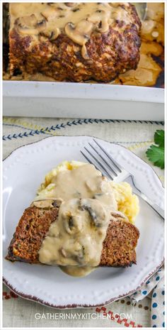 meatloaf with mushroom gravy and mashed potatoes on a white plate