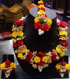 a necklace and earring set made out of flowers