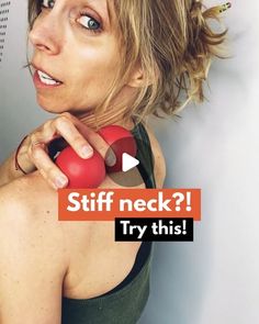 a woman holding a red object in her right hand with the caption stiff neck? try this