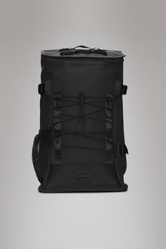 the back view of a black backpack with straps on it, against a gray background