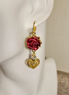 These pretty rose and heart rose gold earrings are brand new and made by me. An extra extra multicolor sparkle charms add a bit of shimmer to the piece. All aspects of the earrings are rose gold plated over alloy metal. Leverback attachment.  Measures just about 2.25" in length. Made with love.