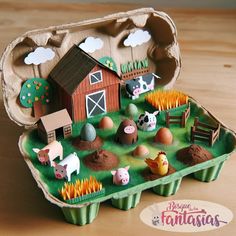 an egg carton filled with farm animals and eggs on top of a wooden table