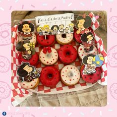 a box filled with lots of donuts covered in frosting and cartoon character magnets