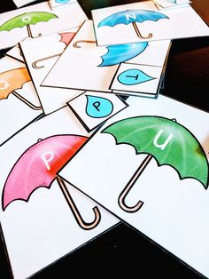 several cards with umbrellas and letters on them