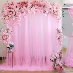 a pink wedding backdrop with flowers on it