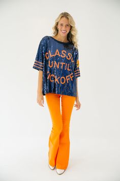 This CLASSY UNTIL KICKOFF TIGER SEQUIN TOP is the perfect way to show school spirit for the big game. Featuring a mix of navy and orange, this top let's you represent your team in style with a tiger patch accent on the sleeve. You'll be sure to stand out on gameday. All orders are currently shipping within 14 business days. To receive item quicker, expedited shipping is available at checkout. Collegiate Blue Tops For Cheerleading, Team-colored Tops For Fall With Team Spirit, Blue School Spirit Tops For Cheerleading, Blue Varsity Tops For Game Day, Collegiate Navy Top For Game Day, Blue Tops For Cheerleading With School Spirit Style, Sports Fan Tops With Letter Print For Fall, Fall Sports Fan Tops With Team Name, Fall Sports Fan Tops With Letter Print