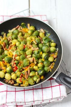 a pan filled with brussel sprouts and other vegetables