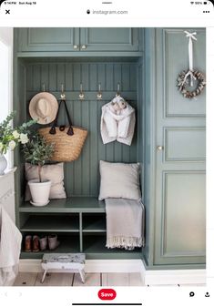 an image of a room with green cupboards and hats on the wall, shoes hanging from hooks