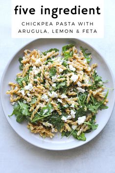 a white plate topped with pasta and spinach covered in feta text reads five ingredient chicken pasta with arugula lemon & feta