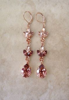 "Stunning pair of earrings featuring crystals in morganite pink and light burgundy. 2 7/8\" long. Rose gold metal finish. Thanks for stopping by!" Make Jewelry For Beginners, Jewelry For Beginners, Fall Wedding Jewelry, Long Crystal Earrings, Light Burgundy, Geode Jewelry, Yule Ball, Pretty Jewelry Necklaces, Earrings Chandelier