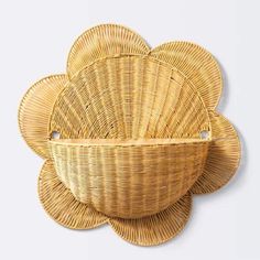 three wicker baskets sitting on top of each other in front of a white wall